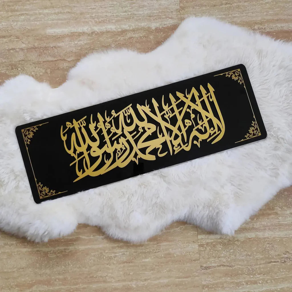 Black strip with gold Arabic calligraphy on a white fur surface