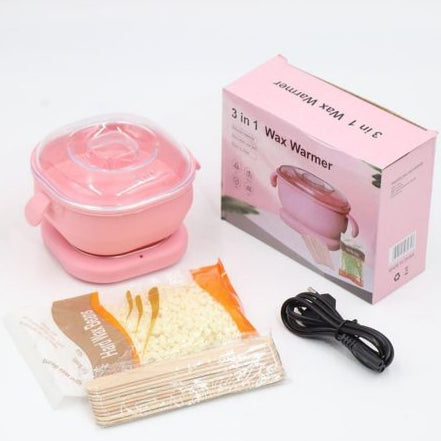 Pink wax warmer with packaging, towels, and a cable on a white background