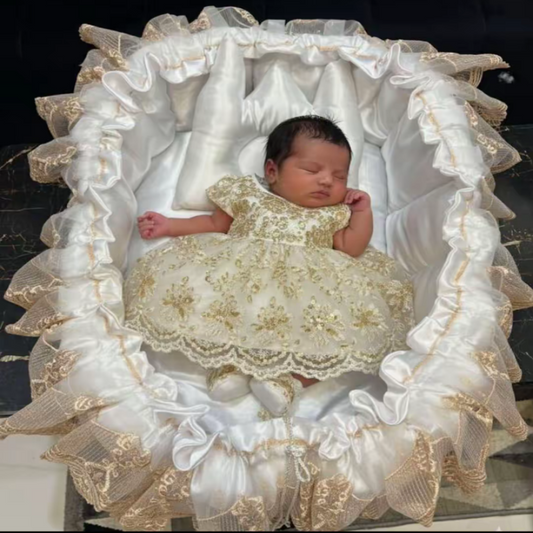 Newborn baby in a decorative crib with ruffled edges